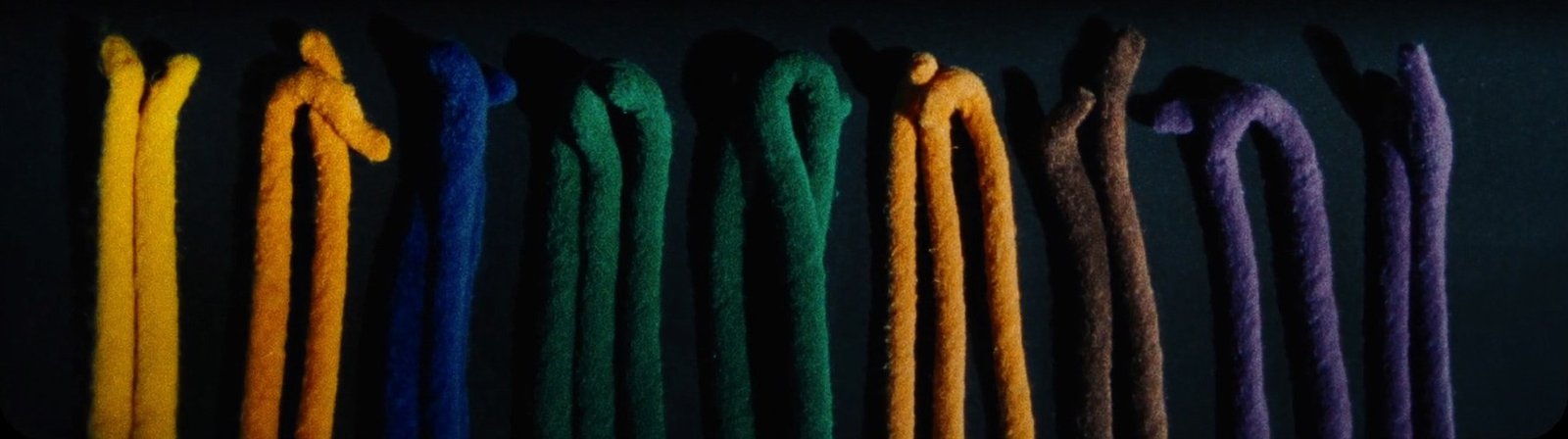 Hand-dyed capoeira cords laid out in color order