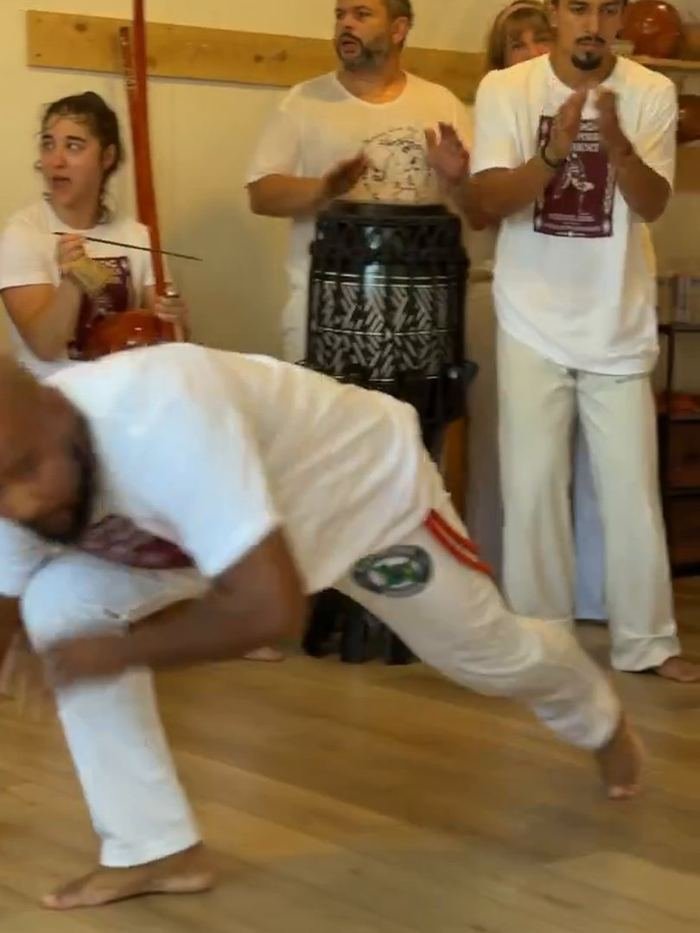 A player low in the game at Capoeira Experience 2026