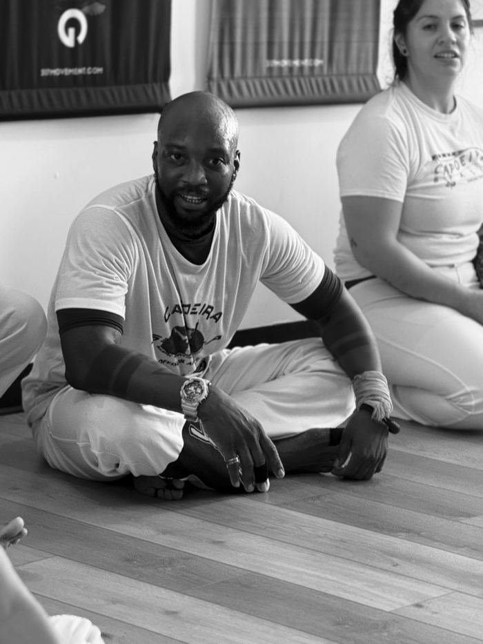 A guest instructor sitting in the circle between games