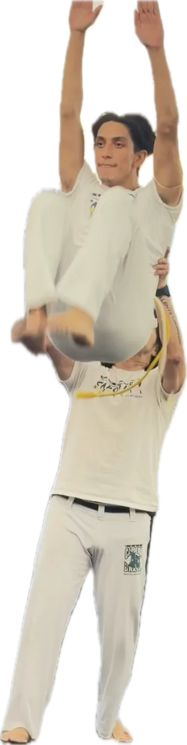 Two capoeiristas, one going up over the other