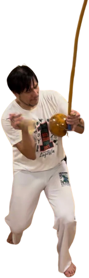 A capoeirista playing the berimbau